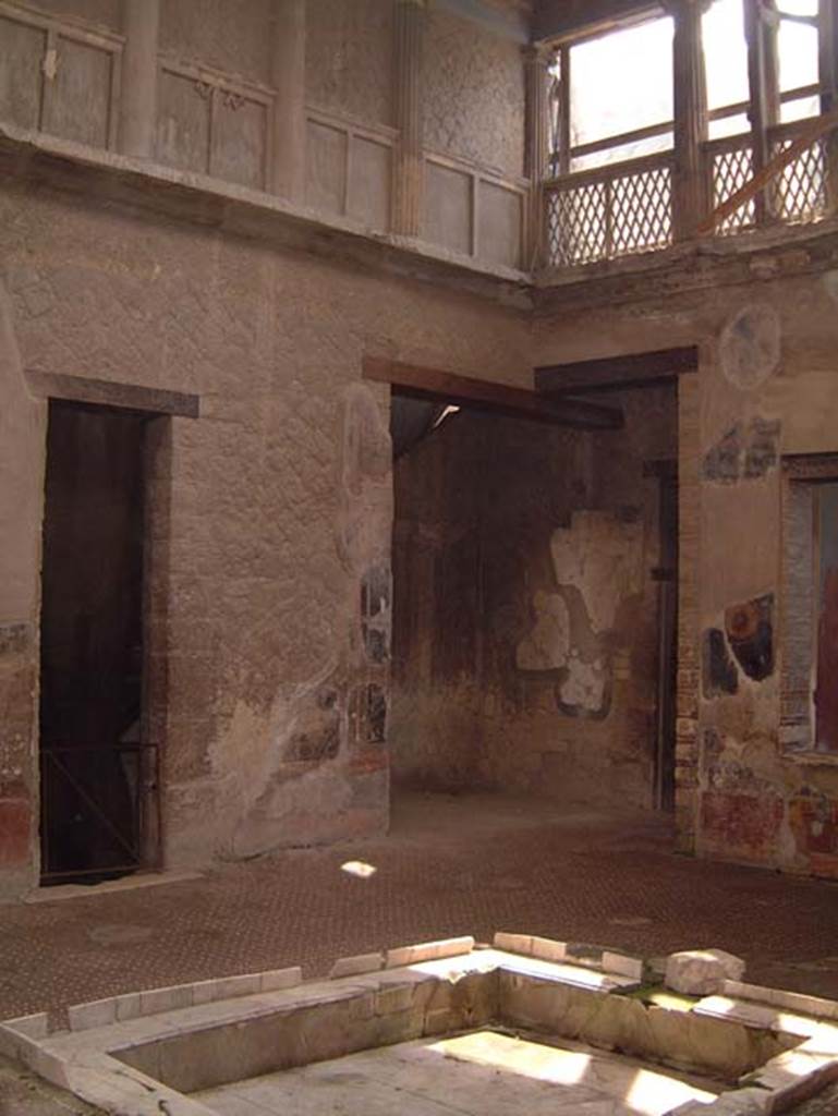 V.1 Herculaneum, May 2001. 
Looking towards north-east corner of atrium (room 8) with doorway into room 7, centre right. 
Photo courtesy of Current Archaeology.